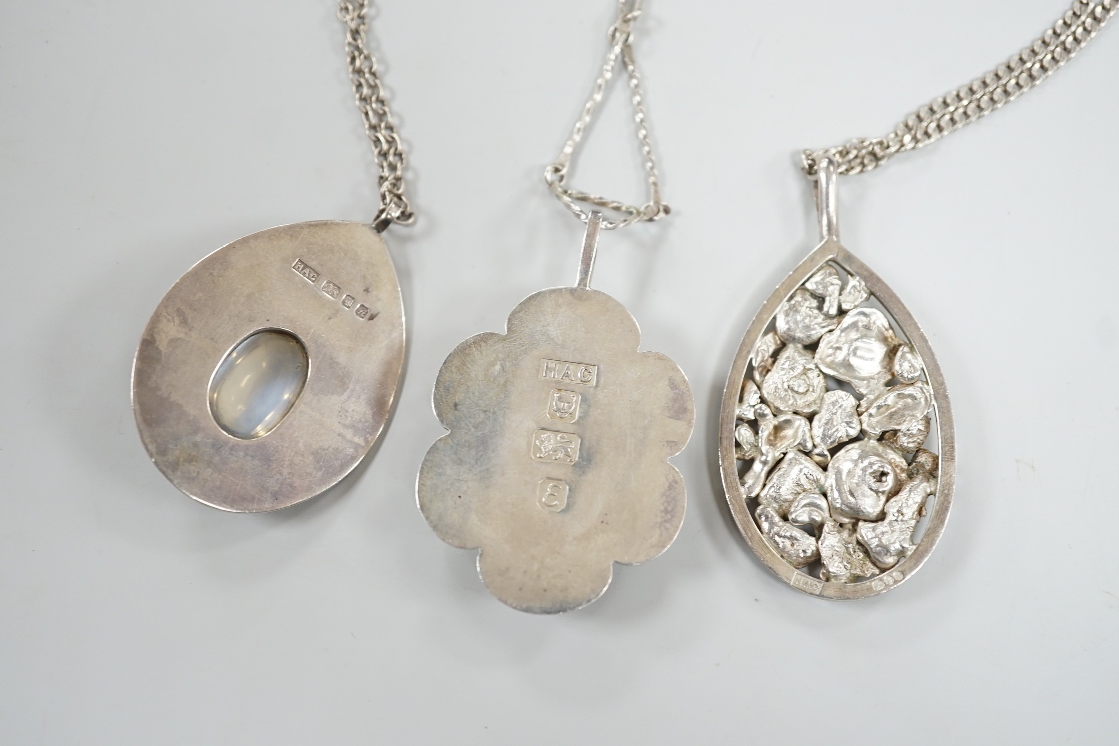 Three modern silver pendants by H.A. Crawshaw? including moonstone set pear shaped pendant, 53mm, all with chains.